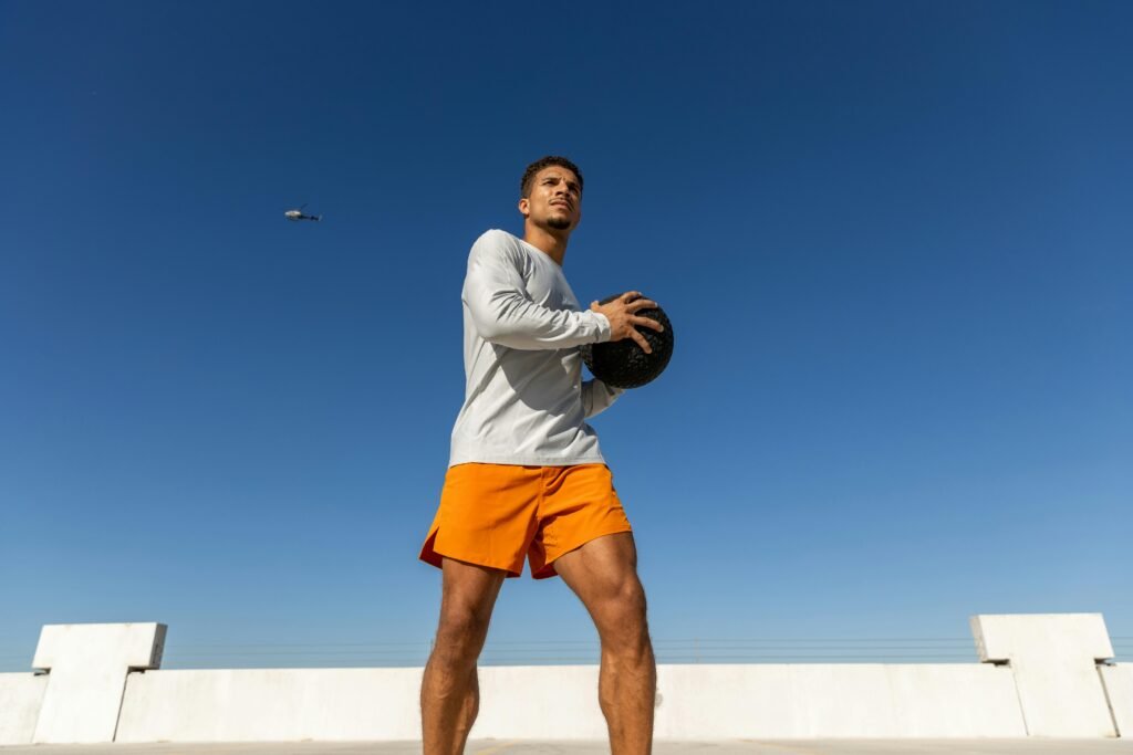 Man exercising with medicine ball on rooftop in Austin, Texas.